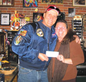 photo by Rhonda HunterAl Hunter presents a check to Jan DeFerbrache for Gaia Works.