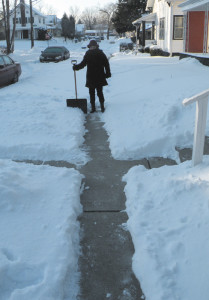 Paula shoveling her sidewalk.