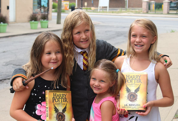 photo by Julie YoungOn July 31, fans of Harry Potter came to Bookmamas to celebrate the fictional wizard’s birthday and get their copies of the latest installment of the series. Cake and butter beer were on hand, and many followed Dumbledore in a parade through Irvington. Here, some happy readers posed with their new books.