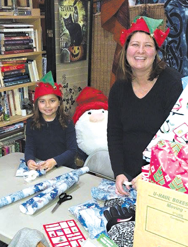 submitted photoManda Montes and her helper wrapped gifts to go to needy children in the community.