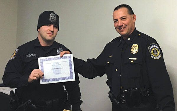 submitted photoIMPD East District Officer Daniel Hiser (left) was recently named officer of the month for East District. Here, Commander Spurgeon of East District presents the officer with the award.