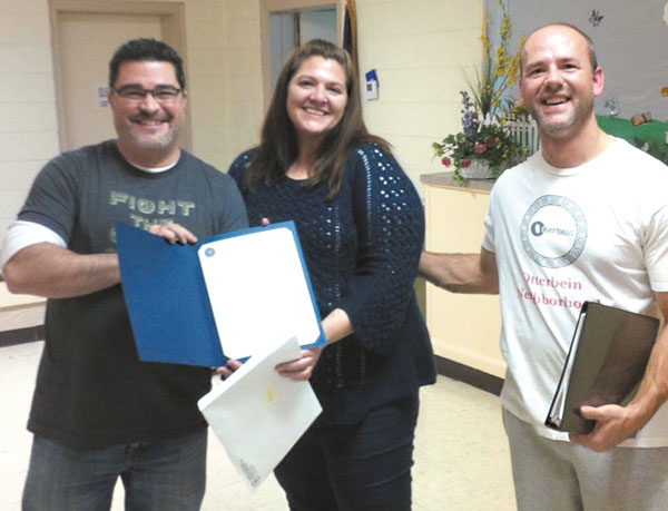 submitted photoCity-County Council member Zach Adamson (L) presented Beth and Tim Barton with a City-County Council proclamation at the November at the Otterbein Neighborhood Association community meeting for their dedication and commitment to Pogue’s Run Art & Nature Park Task Force organizers and all the hard work they put in to revitalizing Pogue’s Run Art & Nature Park.