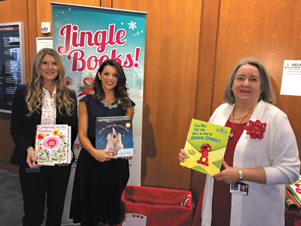 submitted photo
Indianapolis First Lady Stephanie Hogsett (left) is joined by Lindsay Szostak and Indianapolis Public Library CEO Jackie Nytes (right) to kick off the Library’s Jingle Books campaign to provide books as gifts to all children in Indianapolis. Jingle Books donation boxes and free gift wrap stations are located at all IndyPL locations through Dec. 22.