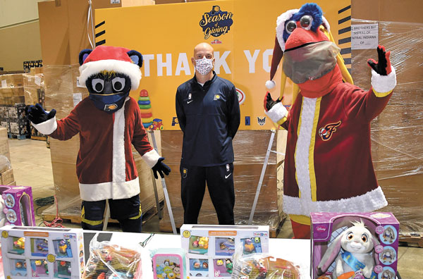 submitted photoINDIANAPOLIS — New Indiana Pacers Coach Nate Bjorkgren is shown along with Pacers mascot Boomer (left) and Fever mascot Freddie (right) on November 17 with toys that are being delivered to children throughout the state, including Lutheran Child & Family Services, La Plaza Holiday Assistance Program, Shepherd Community Center, and Edna Martin Christian Center among many others, as part of their Season of Giving. For the 11th straight year, the Pacers and JAKKS Pacific have partnered to deliver a total of more than 400,000 toys.  This year, 30,000 toys will be delivered.  
